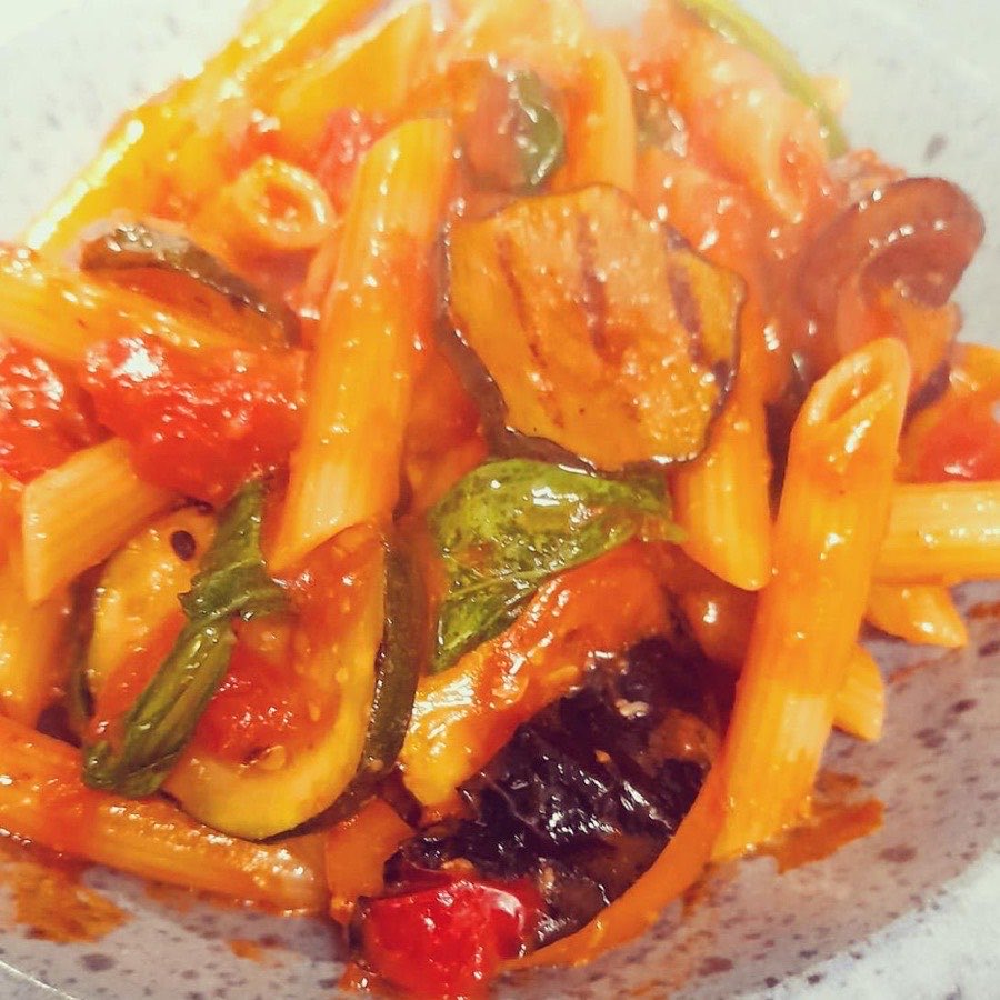 Penne with aubergine, courgette and fresh basil in tomato sauce